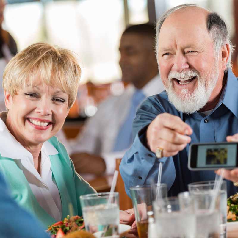 Senior couple enjoying themselves at a restaurant.